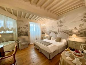 a bedroom with a bed and a bath room with a tub at La Corte Di Ambra in Cortona