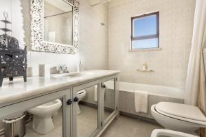 a bathroom with a sink and a toilet and a tub at Casa da Ermida in Budens +17 photos