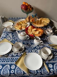 a table with a blue and white table cloth with food at Ludwig Guesthouse in Lagodekhi