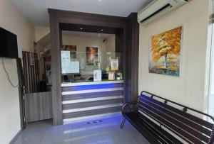 a store entrance with a bench in front of a store at NGS Hotel in Kuantan