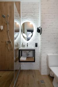 a bathroom with a sink and a mirror at Baza Smart Hotel in Bukovel