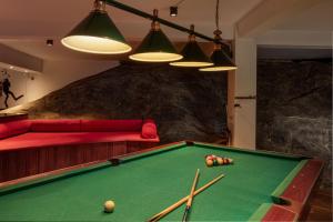 a billiard room with a pool table and a couch at Earl's Regency Hotel in Kandy