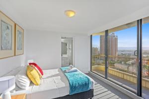 
a bedroom with a bed and a window at Boulevard North Holiday Apartments in Gold Coast

