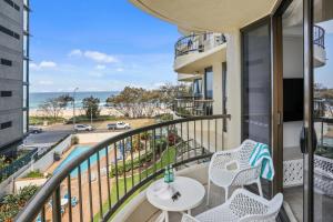 
a balcony overlooking a beach with a view of the ocean at Boulevard North Holiday Apartments in Gold Coast

