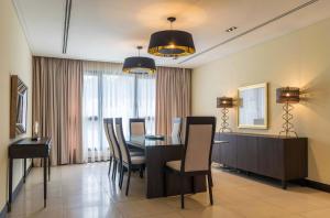 a dining room with a table and chairs at The Seattle Residences and Spa in Lagos