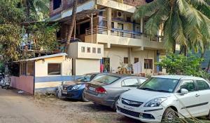 a group of cars parked in front of a building at Serina House Malvan in Malvan