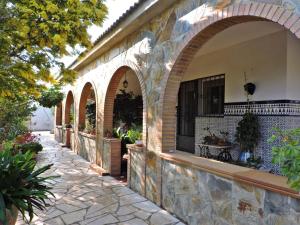 a building with arched windows and a stone walkway at Doree 365 in L'Ametlla de Mar