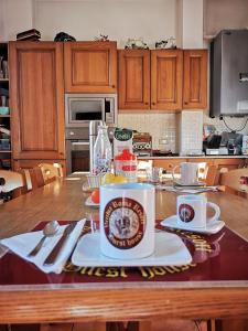 a kitchen with a table with a cup of coffee on it at Vecchia Roma Resort in Rome