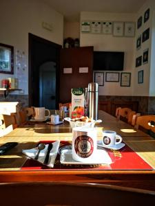 a table with a cup of coffee on top of it at Vecchia Roma Resort in Rome
