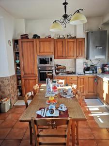 a kitchen with a wooden table with chairs in it at Vecchia Roma Resort in Rome