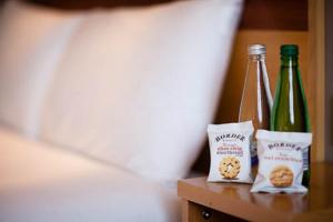 two bottles of beer and cookies on a table at Leonardo Hotel Aberdeen in Aberdeen