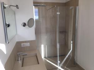 a bathroom with a shower and a sink at Attico Palazzo di Vetro in Luino +20 photos