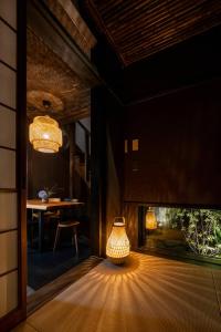 a lamp in a room next to a fish tank at Yoinotake Machiya House in Kyoto +32 photos