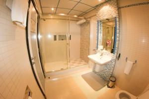 a bathroom with a sink, toilet and bathtub at Elite Resort & Spa in Manama