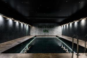 a swimming pool at night with a sign that reads history at HISTORY Boutique Hotel & SPA in Irkutsk