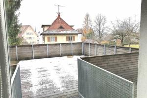 a balcony with a wooden fence and a house at Dimai House No 17 Dornbirn Zentrum in Dornbirn