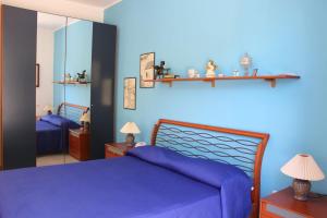 Ein Bett oder Betten in einem Zimmer der Unterkunft Villetta Nina&Ignazio a 50m dal mare