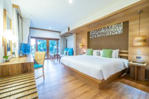 a bedroom with a large bed and a table and chairs at Ao Prao Resort in Ko Samed