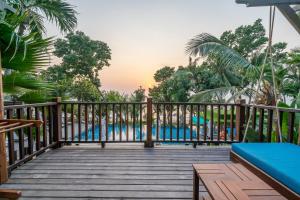 a wooden deck with a bench and a pool at Ao Prao Resort in Ko Samed