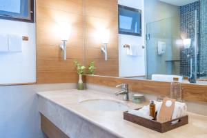 a bathroom with a sink and a mirror at Ao Prao Resort in Ko Samed