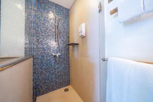 a bathroom with a shower with blue tiles at Ao Prao Resort in Ko Samed