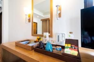 a bathroom counter with a sink and a mirror at Ao Prao Resort in Ko Samed