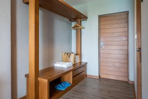 a closet with a wooden dresser and a wooden door at Ao Prao Resort in Ko Samed