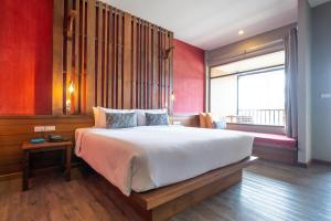 a bedroom with a large bed and a window at Ao Prao Resort in Ko Samed