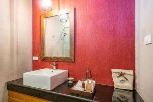 a bathroom with a sink and a mirror at Ao Prao Resort in Ko Samed