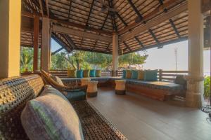 a pavilion with couches and chairs on a patio at Ao Prao Resort in Ko Samed