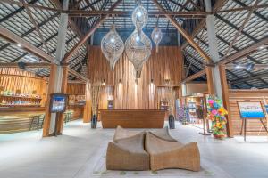 a large room with wooden walls and wooden furniture at Ao Prao Resort in Ko Samed