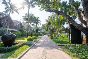 a street in front of a house with palm trees at Ao Prao Resort in Ko Samed