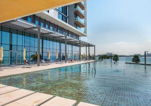 a swimming pool in front of a building at Nasma Luxury Stays - Blue Waters Island in Dubai