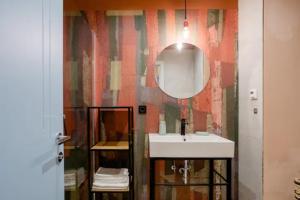 a bathroom with a sink and a mirror at Apartment A.B.S. Secret Oasis in Zagreb