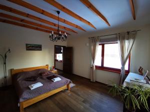 a bedroom with a bed and a large window at Jaunstūrīši in Ādaži