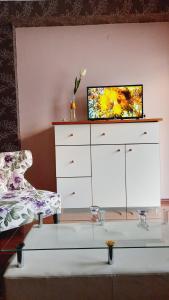 a white dresser with a tv on top of it at Apartmani RALE rooms in Sarajevo