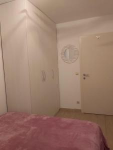 a bedroom with a bed and a white door at Apartmant Angel Wings in Omiš