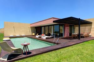 a house with a swimming pool in the yard at Verdura Resort in Ribera