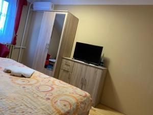 A bed or beds in a room at Németh Vendégház