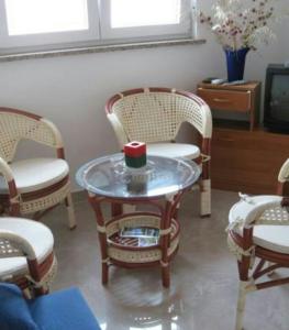 une chambre avec des chaises et une table avec une bougie. dans l'établissement Apartman Dana, à Premantura