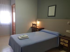 A bed or beds in a room at Hostal Soto