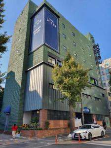 a building with a car parked in front of it at St. 179 Incheon Hotel in Incheon