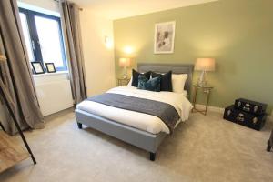 a bedroom with a large bed and a window at Cabot Mews Apartment 2 in Bristol