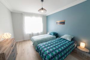 a blue bedroom with two beds and a window at PRESTIGELOC Appart 3 Chambres 2 SDB La Loire in Orléans