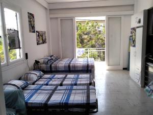 three beds in a room with a balcony at Apollon Apartments H-3 H-4 in Rhodes Town