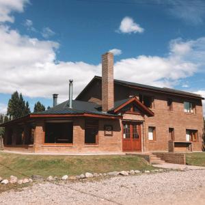 a brick house with a chimney on top of it at Hosteria Miyazato Inn in El Calafate