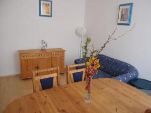 a dining room table with a vase with flowers in it at Hotel Am Römerhof in Bonn