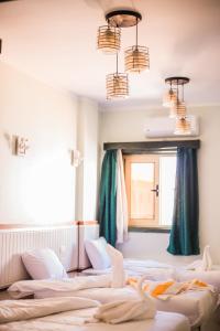 a row of beds in a room with chandeliers at Geo Palace in Dahab