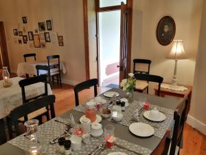 a dining room with a table with dishes on it at Monte Rosa Guesthouse in Rawsonville