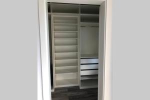 a walk in closet with white shelves at Annas Home II in Sassenburg